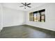 Bright living room features wood-look flooring and a large window with neighborhood views at 3038 Clubview Dr # Ge, Orlando, FL 32822