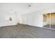 Large living room boasts wood flooring, natural light, and sliding door to patio at 3038 Clubview Dr # Ge, Orlando, FL 32822