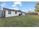 Backyard view showcasing the home's exterior, a well-maintained lawn, and a fenced perimeter at 3121 Heartwood Ave, Winter Park, FL 32792
