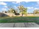 Backyard featuring mature trees, lush lawn, and a privacy fence, creating a serene outdoor space at 3121 Heartwood Ave, Winter Park, FL 32792