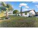 Backyard featuring mature trees, lush lawn, a privacy fence, and a patio with an outdoor grill at 3121 Heartwood Ave, Winter Park, FL 32792