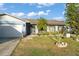 Charming single-story home with a manicured front yard, complemented by a lush green lawn and a welcoming, covered entryway at 3121 Heartwood Ave, Winter Park, FL 32792