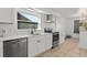 Modern kitchen features stainless steel appliances, white cabinets, and quartz countertops at 3121 Heartwood Ave, Winter Park, FL 32792