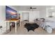 Spacious living room with tile floors, a modern ceiling fan, and a large TV at 3121 Heartwood Ave, Winter Park, FL 32792