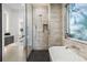 Stylish bathroom with a soaking tub, a glass-enclosed shower, and a modern design for a luxurious feel at 3322 Helen Ave, Orlando, FL 32804