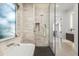 Stylish bathroom with a soaking tub, a glass-enclosed shower, and a modern design for a luxurious feel at 3322 Helen Ave, Orlando, FL 32804