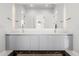 Bright bathroom featuring a double vanity with modern fixtures and a large mirror at 3322 Helen Ave, Orlando, FL 32804