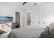 Comfortable bedroom with a TV, gray accents and a view to the ensuite bathroom at 3322 Helen Ave, Orlando, FL 32804