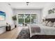 Bright bedroom with a plush rug, king bed, and sliding glass doors to the backyard swimming pool at 3322 Helen Ave, Orlando, FL 32804