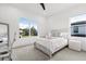 Bright bedroom with large windows offering scenic views, carpet floors, and stylish furniture at 3322 Helen Ave, Orlando, FL 32804
