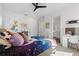 Colorful bedroom with decorative pillows, a ceiling fan, carpet floors, and a well-lit vanity area at 3322 Helen Ave, Orlando, FL 32804