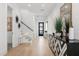 Bright entryway with modern accents, hardwood floors, and a staircase to the second floor at 3322 Helen Ave, Orlando, FL 32804