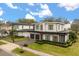 Modern two-story home with a two-car garage, manicured landscaping, and a well-maintained lawn at 3322 Helen Ave, Orlando, FL 32804