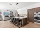 Spacious kitchen features bar seating, stainless appliances, and an adjacent living space at 3322 Helen Ave, Orlando, FL 32804