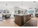 Open-concept kitchen featuring a large island with a sink, stainless steel appliances, and wood floors at 3322 Helen Ave, Orlando, FL 32804