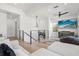 Upstairs living room with modern black metal and glass railings, and lots of light at 3322 Helen Ave, Orlando, FL 32804