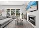 Bright living room featuring a fireplace, large windows and hardwood floors at 3322 Helen Ave, Orlando, FL 32804