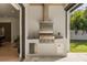 Modern outdoor kitchen featuring stainless steel grill, sink, and storage, perfect for entertaining in the backyard at 3322 Helen Ave, Orlando, FL 32804