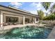 Inviting outdoor living space with a pool, lounge chairs, and an outdoor kitchen with covered seating at 3322 Helen Ave, Orlando, FL 32804