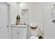 Well-lit bathroom with a single sink vanity, a toilet, and a tiled shower at 355 Gardenia Ct, Kissimmee, FL 34759