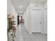 Well-lit hallway with decorative lamps and wall decor leading to living spaces at 355 Gardenia Ct, Kissimmee, FL 34759