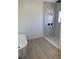 A bathroom with a modern shower area featuring white marble tiling at 4031 Sw 130Th Loop, Ocala, FL 34473