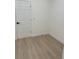 This bedroom features light wood flooring and a white painted door at 4031 Sw 130Th Loop, Ocala, FL 34473