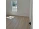 Bright bedroom features wood-look floors, large window, and neutral walls at 4031 Sw 130Th Loop, Ocala, FL 34473