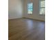 Bright bedroom with two large windows, hardwood floors and natural light at 4031 Sw 130Th Loop, Ocala, FL 34473