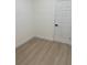 This bedroom features light wood flooring, white walls and a white door at 4031 Sw 130Th Loop, Ocala, FL 34473