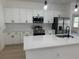 Updated kitchen featuring white cabinets, stainless steel appliances, and a bright, modern design at 4031 Sw 130Th Loop, Ocala, FL 34473