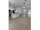 Open-concept kitchen and living area with stainless steel appliances and modern pendant lighting at 4031 Sw 130Th Loop, Ocala, FL 34473