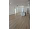 Open-concept living area with light wood floors and modern lighting at 4031 Sw 130Th Loop, Ocala, FL 34473