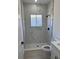 A modern shower featuring white marble tile and black fixtures at 4031 Sw 130Th Loop, Ocala, FL 34473