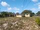 Backyard of home with trees and fencing at 411 Thomas Ave, Frostproof, FL 33843