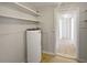 Basement utility area with water heater and shelving at 411 Thomas Ave, Frostproof, FL 33843