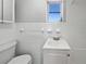 Bathroom with white tiled walls and updated sink at 411 Thomas Ave, Frostproof, FL 33843