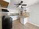 Functional kitchen featuring white cabinets, tile backsplash, and ceiling fan at 411 Thomas Ave, Frostproof, FL 33843