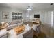 Bright living room features stylish furnishings, neutral decor, and a large window at 411 Thomas Ave, Frostproof, FL 33843