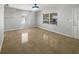 Bright living room featuring tile flooring and two windows at 411 Thomas Ave, Frostproof, FL 33843