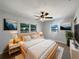 Comfortable bedroom with two windows, ceiling fan, and modern décor at 411 Thomas Ave, Frostproof, FL 33843