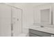 Bright bathroom featuring a shower with glass door and a vanity with a light countertop and large mirror at 4180 Bull St, St Cloud, FL 34772