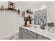 Stylish bathroom featuring a gray vanity, floating shelves, and decorative accents at 4180 Bull St, St Cloud, FL 34772