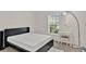 Clean bedroom features a black bed frame with a vanity and large window at 4180 Bull St, St Cloud, FL 34772