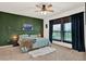 Comfortable bedroom features a ceiling fan, a plush rug, and a green accent wall at 4180 Bull St, St Cloud, FL 34772