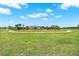 Lush green space with a paved walking path encircling a modern community park and activity area at 4180 Bull St, St Cloud, FL 34772