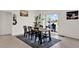 Cozy dining room with a modern table, seating for six, and sliding glass doors to the backyard at 4180 Bull St, St Cloud, FL 34772