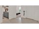 Open view of entryway features neutral tile flooring and a glimpse into a bedroom with a white platform bed at 4180 Bull St, St Cloud, FL 34772