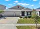 Charming home with a well-manicured lawn, two-car garage, and inviting front porch at 4180 Bull St, St Cloud, FL 34772