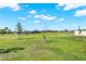 Expansive community green space offers a walking path leading to playground with lush grass and clear skies at 4180 Bull St, St Cloud, FL 34772